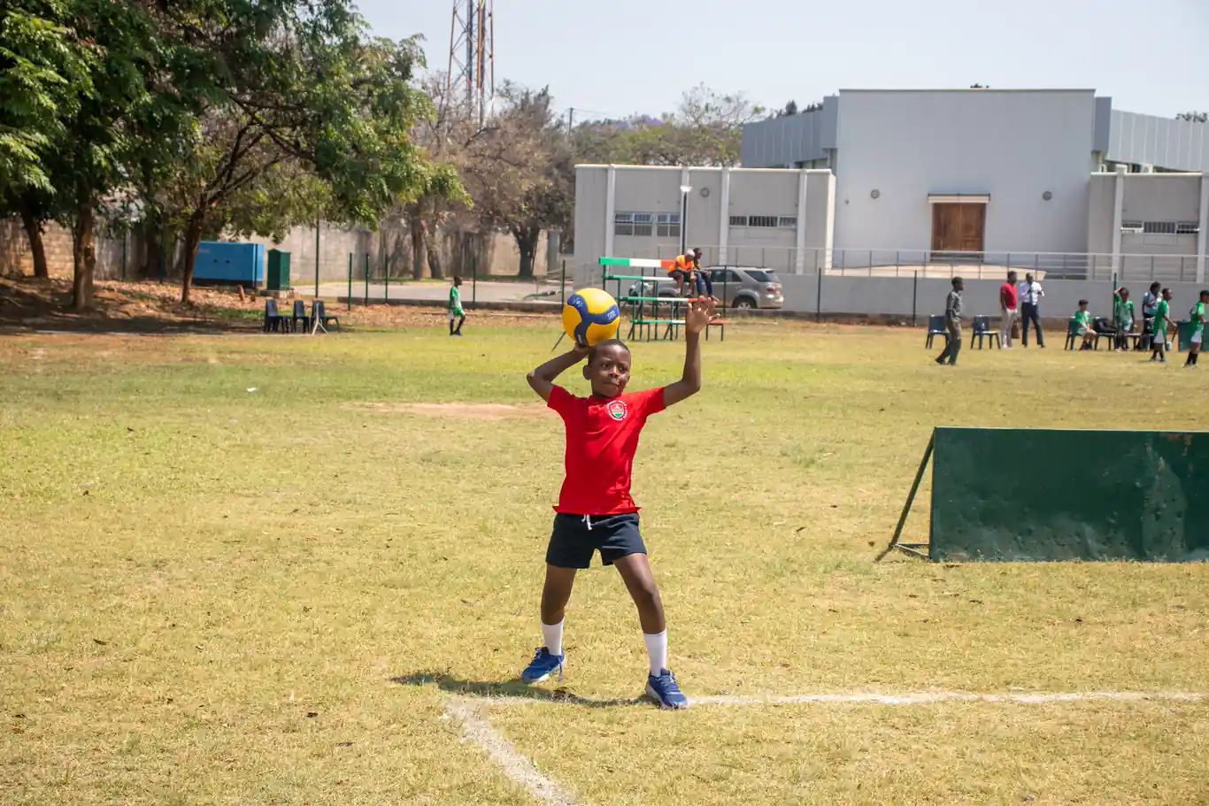 Cherry Hills learner holding a volleyball on the court during the ISAZ U9 Mini Volleyball Tournament